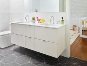 A custom floating bathroom cabinet vanity installed by Metropolitan Cabinets